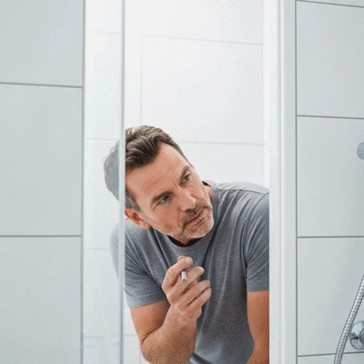 User inspecting a leaking shower